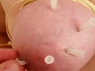 This is an amateur needle play session involving the use of medical hypodermic needle tips to pierce the tits of a masochist woman.